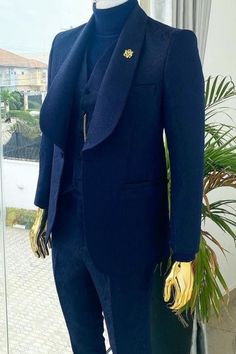 a mannequin wearing a blue suit and yellow gloves in front of a window