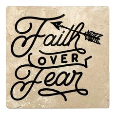 the words faith over fear are written on a stone wall with an arrow in it