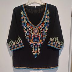 Like New! Never Worn. Unbranded Black Boho Beachy V-Neck Blouse With Floral Embroidery Front And Back! 3/4 Sleeves, Loose Fit, Fully Lined. Material Is Cotton Rayon Blend. Excellent Quality. No Stains, Rips, Or Pulls. Multicolor Embroidered V-neck Top For Vacation, V-neck Blouse With Multicolor Embroidery For Vacation, Black Embroidered V-neck Top For Summer, Black Embroidered Top For Summer Festival, Black V-neck Embroidered Top For Summer, Black Floral Embroidered Blouse For The Beach, Black 3/4 Sleeve Top For Beach, Bohemian Black Top With 3/4 Sleeves, Bohemian V-neck Embroidered Top For Vacation