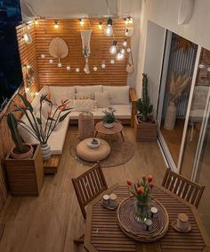 an overhead view of a living room and dining area with wood paneling, potted plants and lights