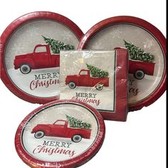 three plates with red truck and christmas tree on the front one has merry christmas written on it