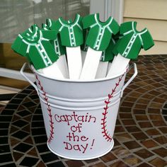 a bucket filled with green and white baseball bats