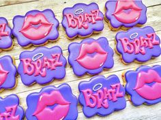 decorated cookies with pink and purple icing on a table