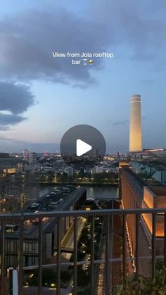 an image of a view from the top of a building at night with lights on