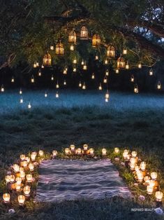 many lit candles are arranged in the shape of a heart