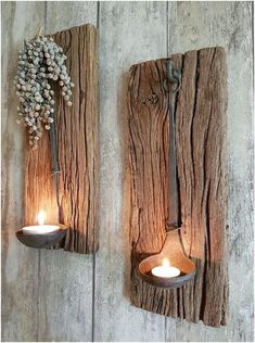 two wooden wall sconces with candles on them