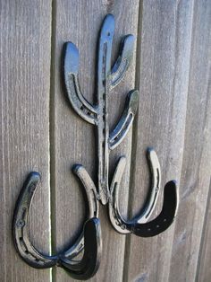 a metal hook on the side of a wooden fence