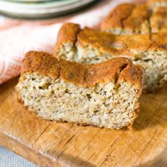 two slices of banana bread sitting on top of a wooden cutting board