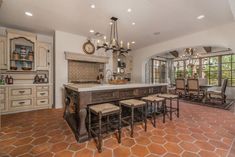 a large kitchen with an island in the middle