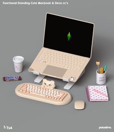 a laptop computer sitting on top of a desk next to a cup of coffee and marshmallows