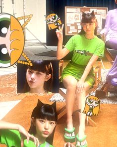 two girls in green shirts and one girl with cat ears