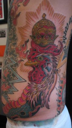 the back of a man's stomach with tattoos on it and a bird wearing a crown