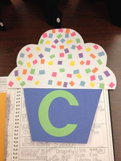 a paper cut out of a cupcake with the letter c on it's side