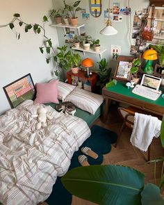 a bedroom with lots of plants on the wall and a bed in front of it