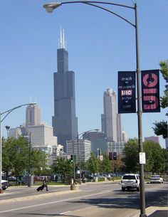 a city street with tall buildings in the background