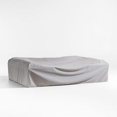 a white couch covered with a sheet on top of it