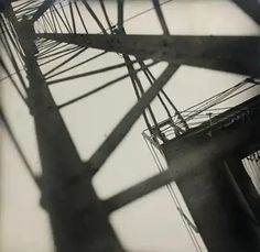 black and white photograph of the top of a bridge with wires on it's sides