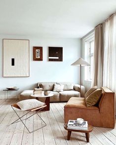 a living room with white walls and wooden floors