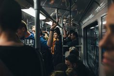 a group of people riding on a subway train