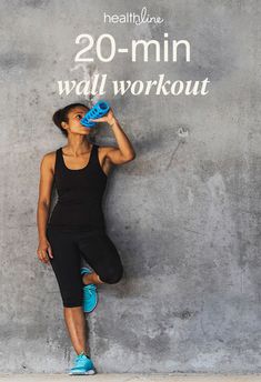 a woman standing in front of a wall holding a blue object with the words 20 - min wall workout written on it