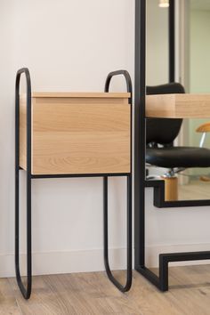 a wooden table sitting in front of a mirror on top of a hard wood floor