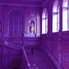 the stairs are made of marble and have purple hued lighting on them as well as an image of a statue