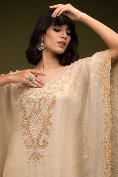 Ivory and beige cutdana embroidered cutwork floral swirl patterns. Comes with an inner. - Aza Fashions Beige Raw Silk Dress With Resham Embroidery, Beige Raw Silk Dress For Eid, Elegant V-neck Kaftan For Festivals, Elegant Cream Dress For Festivals, Traditional Kaftan With Intricate Embroidery For Reception, Unstitched Kaftan For Wedding Festivities, Beige Dresses With Resham Embroidery In Traditional Drape, Chanderi V-neck Sets For Wedding, V-neck Chanderi Sets For Wedding