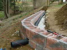 a brick wall being built into the ground