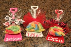 three candy bags with tags on them sitting on a counter