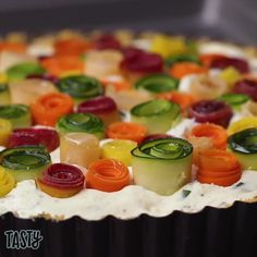 a close up of a cake with carrots and cucumbers on it's icing