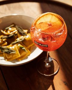 a bowl of food and a drink on a table