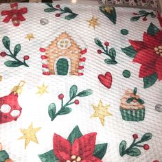 a white quilt with christmas decorations on it