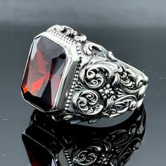 Elevate your style with this exquisite handmade garnet ruby stone ring. Crafted from 925k sterling silver, this vintage Ottoman-inspired piece features a stunning red stone centerpiece and intricate hand-engraved details. The perfect blend of timeless elegance and intricate artistry, this ring is a true statement accessory. Whether dressing up for a special occasion or adding a touch of sophistication to your everyday look, this garnet ruby ring is sure to turn heads. With its unique design and high-quality materials, this ring is built to last and will become a cherished addition to your jewelry collection. Embrace the rich history and craftsmanship behind this remarkable piece. • Gender : Male / Female• Material : 925K Sterling Silver• Total weight : 19 Grams• Gemstone : Garnet Ruby Ston Garnet Stone Ring, Emerald Stone Rings, Mystic Topaz Ring, Ottoman Styling, Engraved Ring, Engraved Wedding, Lapis Lazuli Ring, Men Ring, Citrine Stone