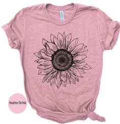 Our Sunflower Graphic T-shirt for Women is the perfect addition to your summer wardrobe. The bright yellow sunflower design on a soft and comfortable cotton material makes it the ideal T-shirt for everyday wear. The short-sleeve, crew  neck shirt is perfect for the hot weather, and the lightweight, breathable fabric will keep you cool and comfortable all day long. This T-shirt is a great gift idea for any woman who loves florals and nature. The vintage-inspired sunflower design is trendy, cute and playful, making it perfect for casual, boho-chic or sustainable fashion. Available in various sizes, including plus size, this T-shirt is suitable for women of all shapes and sizes. It is part of our collection of women's graphic T-shirts and will look great paired with your favorite denim shorts Summer Casual T-shirt With Sunflower Print, Cotton Crew Neck T-shirt With Sunflower Design, Trendy Summer T-shirt With Sunflower Print, Summer Sunflower Design Short Sleeve T-shirt, Summer Graphic Tee With Sunflower Print, Yellow Sunflower T-shirt For Spring, Yellow Sunflower Design T-shirt For Spring, Yellow Sunflower Print Graphic Tee, Summer Cotton T-shirt With Sunflower Design