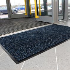 a blue rug on the ground in front of a building