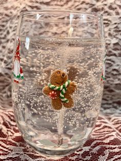 a glass filled with water and a teddy bear