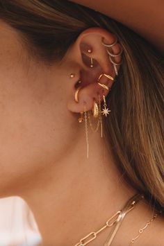 a close up of a person with ear piercings