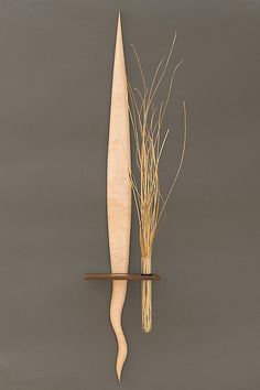 a wooden surfboard and some dry grass on a shelf