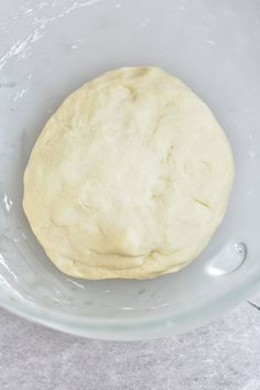 a ball of dough in a glass bowl