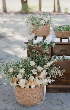 some baskets with flowers are sitting on a table