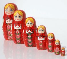 a row of red nesting dolls sitting next to each other