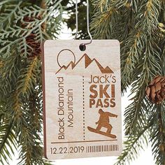 a wooden ski pass ornament hanging from a tree