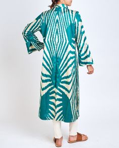 Our classic caftan duster. Inspired by the caftan garments of Uzbek royalty, the Fergana is designed with livable luxury in mind. Slits on the sleeve and the body of the caftan are created to highlight the jewelry and clothing that is worn underneath. Mandarin collar Sleeve and side slits 100% silk ikat handwoven in Tashkent, Uzbekistan Tailored in Istanbul, Turkey Dry clean only One size fits most Model is 5'7" and wears size 4. Green Silk Long Sleeve Kaftan, Silk Long Sleeve Kaftan For Eid, Long Sleeve Dabka Kimono For Eid, Silk Ikat Print Long Sleeve Kaftan, Tashkent Uzbekistan, Tie Dye Fashion, Silk Ikat, Istanbul Turkey, Mandarin Collar