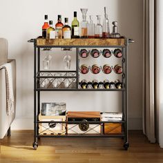 a bar cart filled with liquor bottles and glasses on top of a hard wood floor