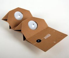 two cardboard boxes with lights inside on a white surface