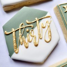 decorated cookies with the word twist spelled in gold and white icing on top of each cookie