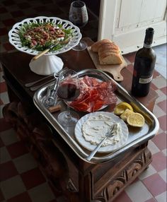 an assortment of food and wine on a table