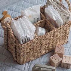 a wicker basket filled with diapers and toys