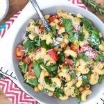 a white bowl filled with pasta salad on top of a table