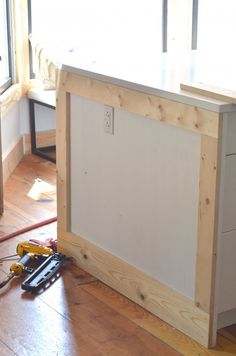 a workbench with tools on the floor next to it